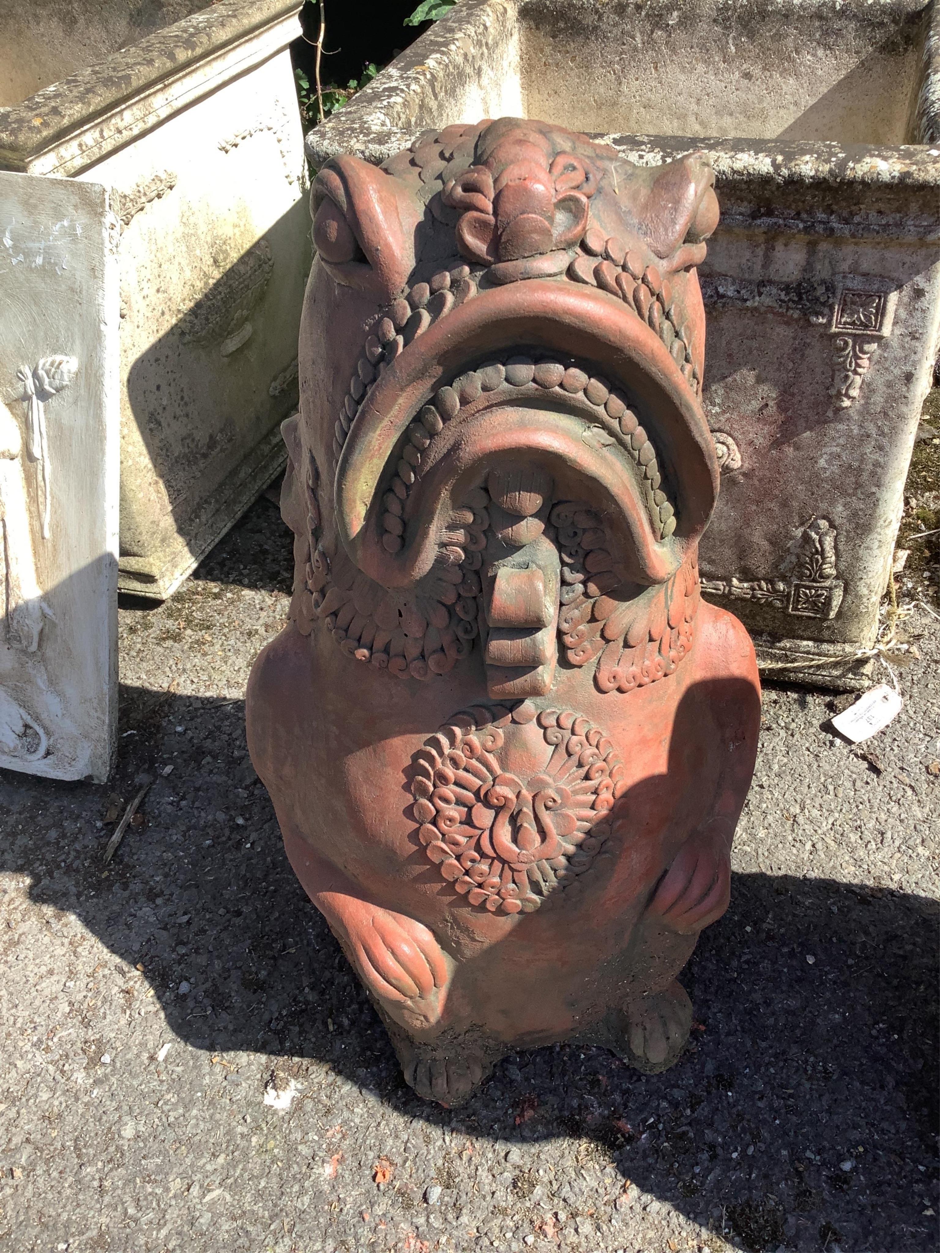 A pair of cast terracotta Oriental fish garden ornaments, height 61cm